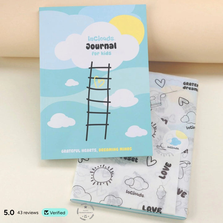 InClouds Journal for kids titled 'Grateful Hearts, Dreaming Minds' featuring a blue sky and ladder design, shown with branded doodle wrapping paper and a 5.0-star verified rating badge.
