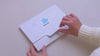 Video showing the unboxing of the InClouds. Journal set for kids: opening the branded mailer box, decorative tissue paper, the prompt journal, stickers, and door hanger.